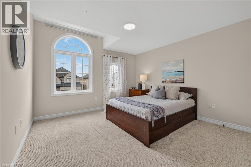 Bedroom with light carpet and baseboards - 100 Garinger Crescent, Binbrook, ON - Indoor Photo Showing Bedroom