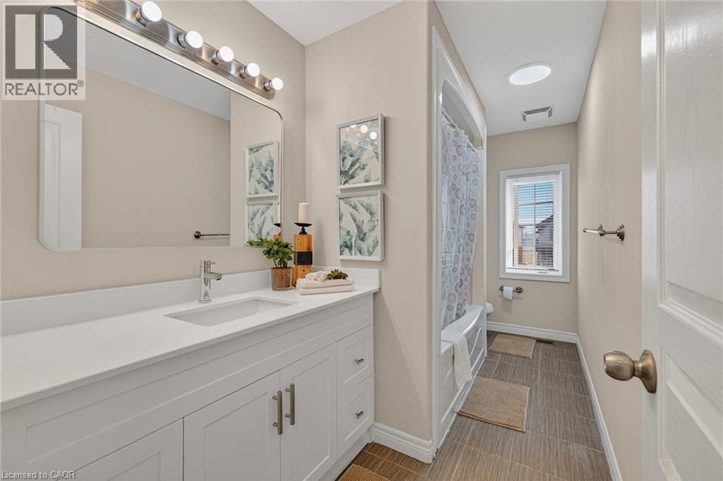 Bathroom with vanity and shower / bathtub combination with curtain - 100 Garinger Crescent, Binbrook, ON - Indoor Photo Showing Bathroom