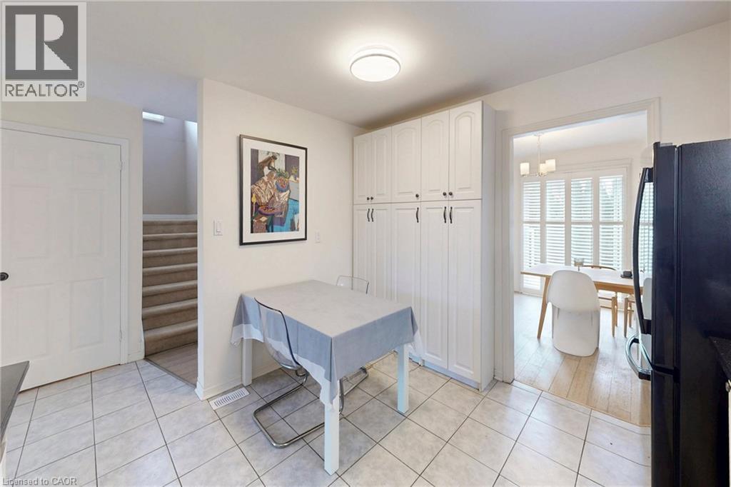 Dining area featuring stairs and light tile patterned flooring - 62 Como Place, Hamilton, ON - Indoor Photo Showing Other Room