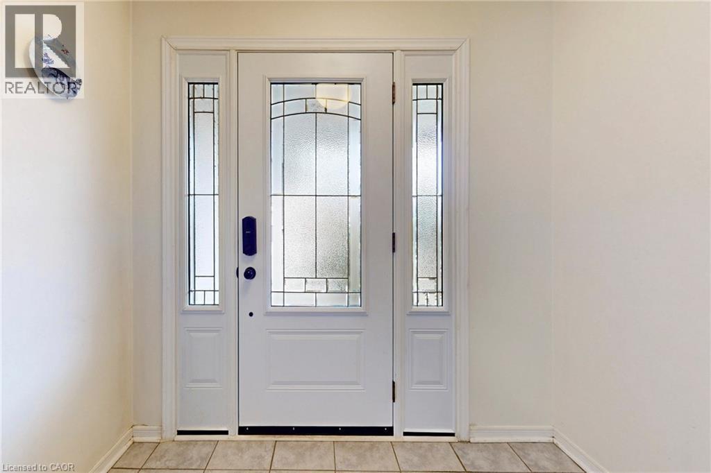 Doorway to outside with tile patterned floors and baseboards - 62 Como Place, Hamilton, ON - Indoor Photo Showing Other Room
