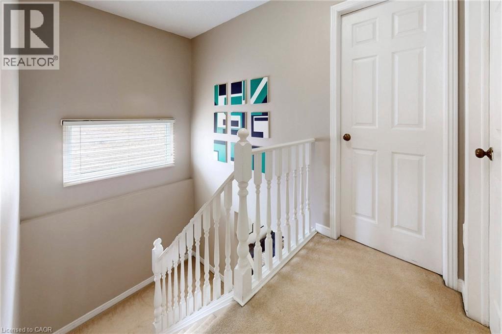 Hallway featuring light colored carpet and an upstairs landing - 62 Como Place, Hamilton, ON - Indoor Photo Showing Other Room