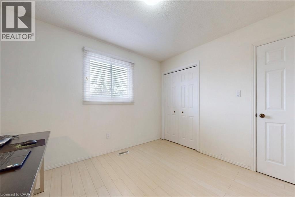 Unfurnished office featuring a textured ceiling and light wood-style floors - 62 Como Place, Hamilton, ON - Indoor Photo Showing Other Room