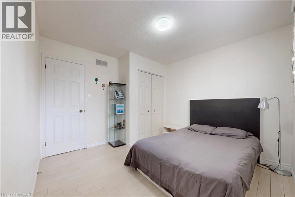 Bedroom with light wood-style flooring and a closet - 62 Como Place, Hamilton, ON - Indoor Photo Showing Bedroom
