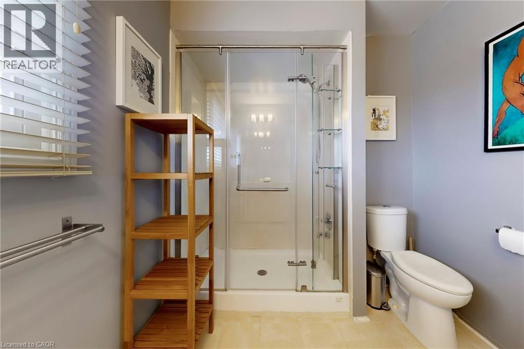 Bathroom featuring toilet and a shower stall - 62 Como Place, Hamilton, ON - Indoor Photo Showing Bathroom