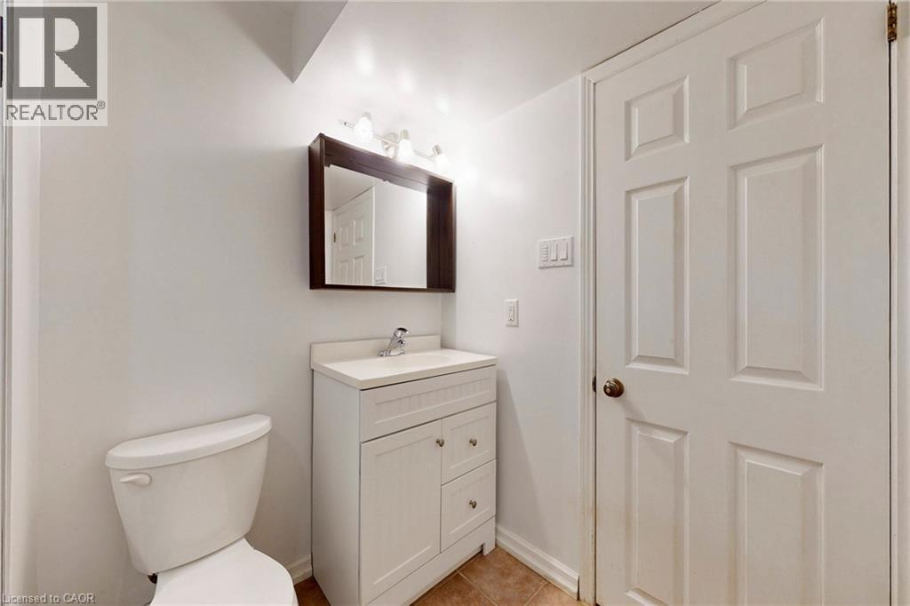 Bathroom with vanity and light tile patterned floors - 62 Como Place, Hamilton, ON - Indoor Photo Showing Bathroom