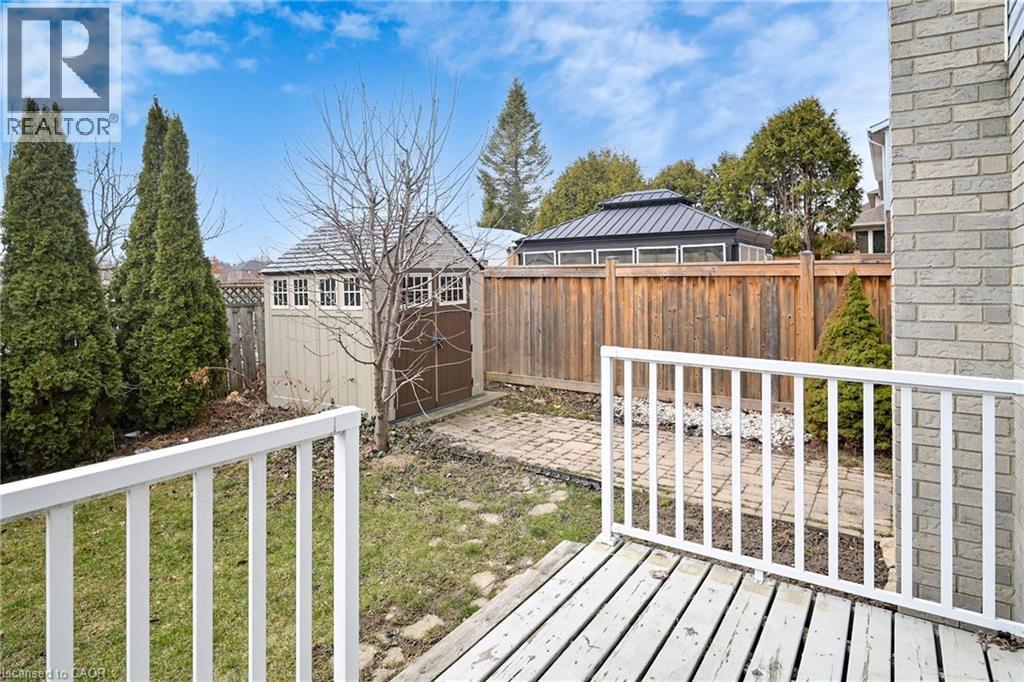 Fenced backyard featuring a storage unit and a deck - 62 Como Place, Hamilton, ON - Outdoor With Deck Patio Veranda