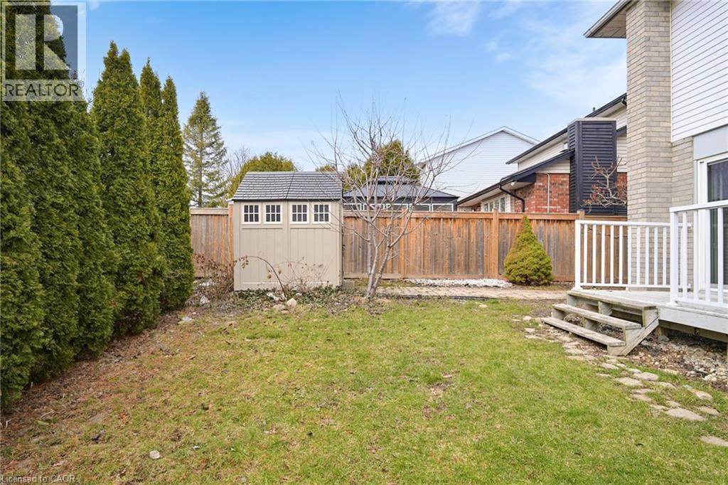 Fenced backyard with a wooden deck and a storage shed - 62 Como Place, Hamilton, ON - Outdoor