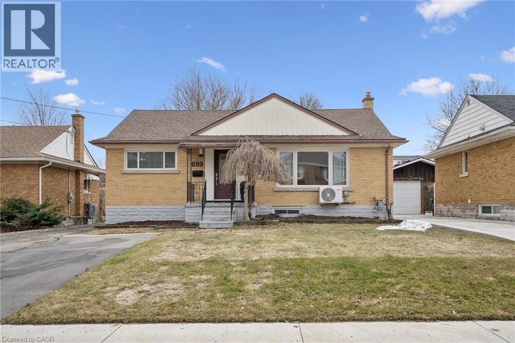 View of front of home featuring brick siding, a front lawn, a chimney, and an outdoor structure - 699 Frederick Street, Kitchener, ON - Outdoor