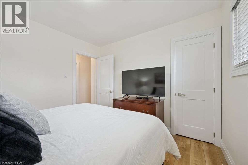 Bedroom with light wood-type flooring and baseboards - 699 Frederick Street, Kitchener, ON - Indoor Photo Showing Bedroom
