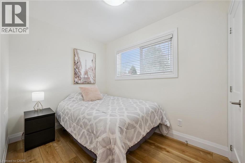 Bedroom with light wood-style flooring and baseboards - 699 Frederick Street, Kitchener, ON - Indoor Photo Showing Bedroom