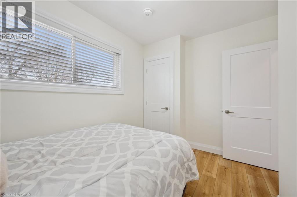 Bedroom with light wood-style floors and baseboards - 699 Frederick Street, Kitchener, ON - Indoor Photo Showing Bedroom