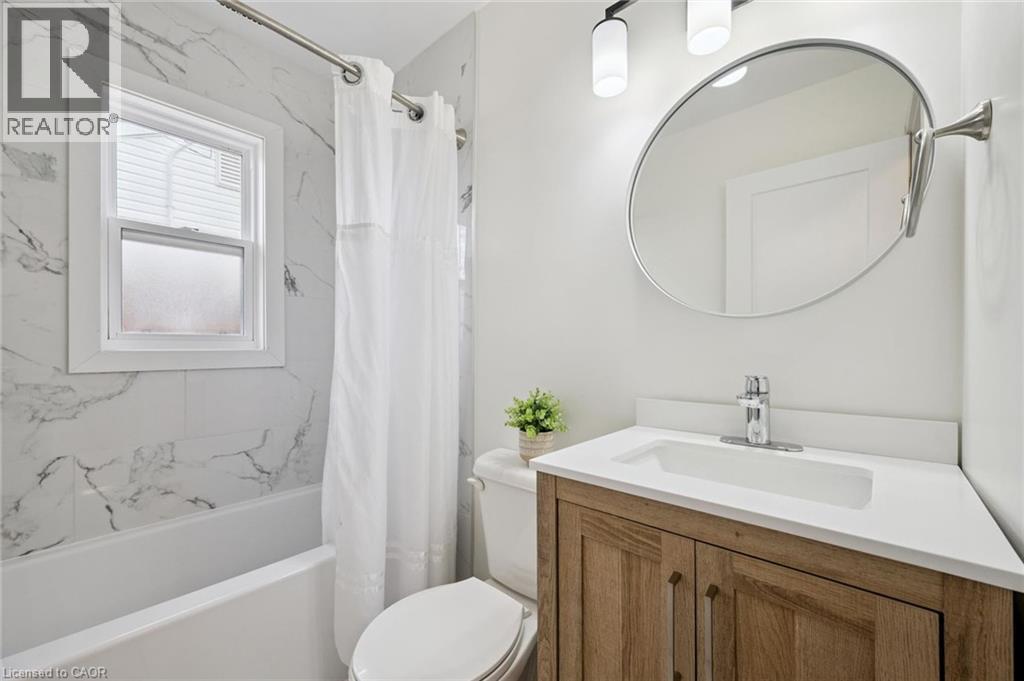 Bathroom featuring vanity and shower / tub combo with curtain - 699 Frederick Street, Kitchener, ON - Indoor Photo Showing Bathroom