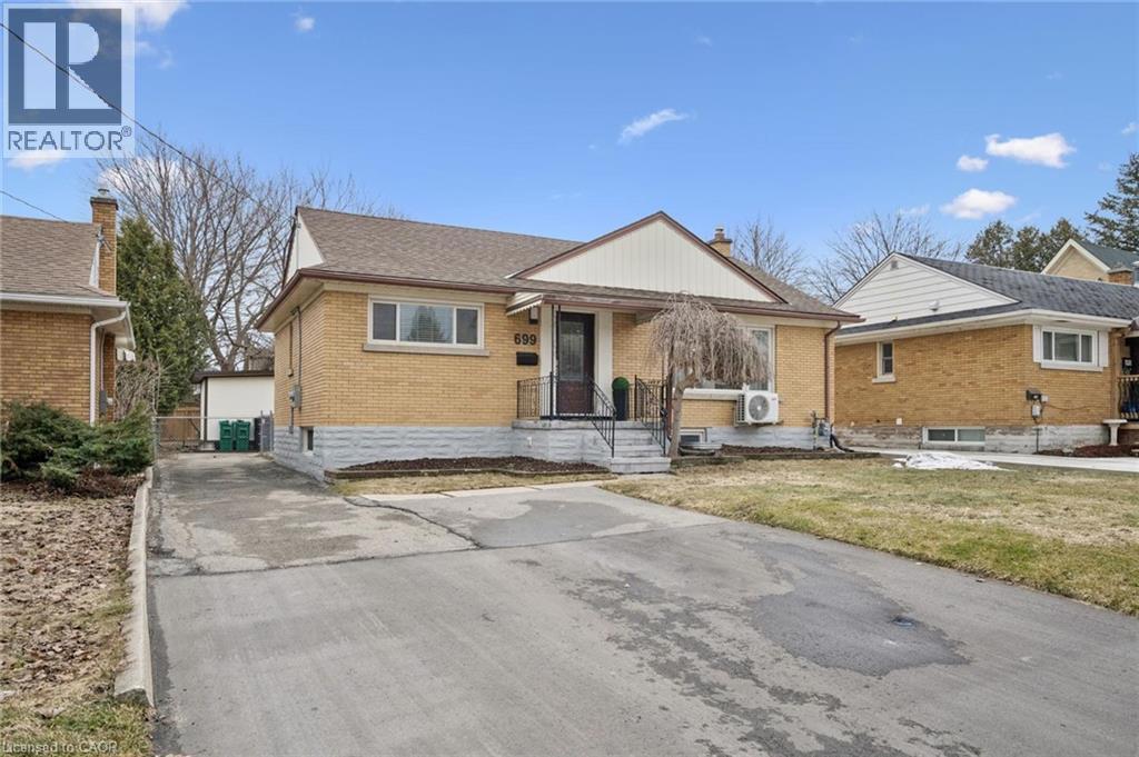 Bungalow-style home featuring brick siding, a shingled roof, and a chimney - 699 Frederick Street, Kitchener, ON - Outdoor With Facade