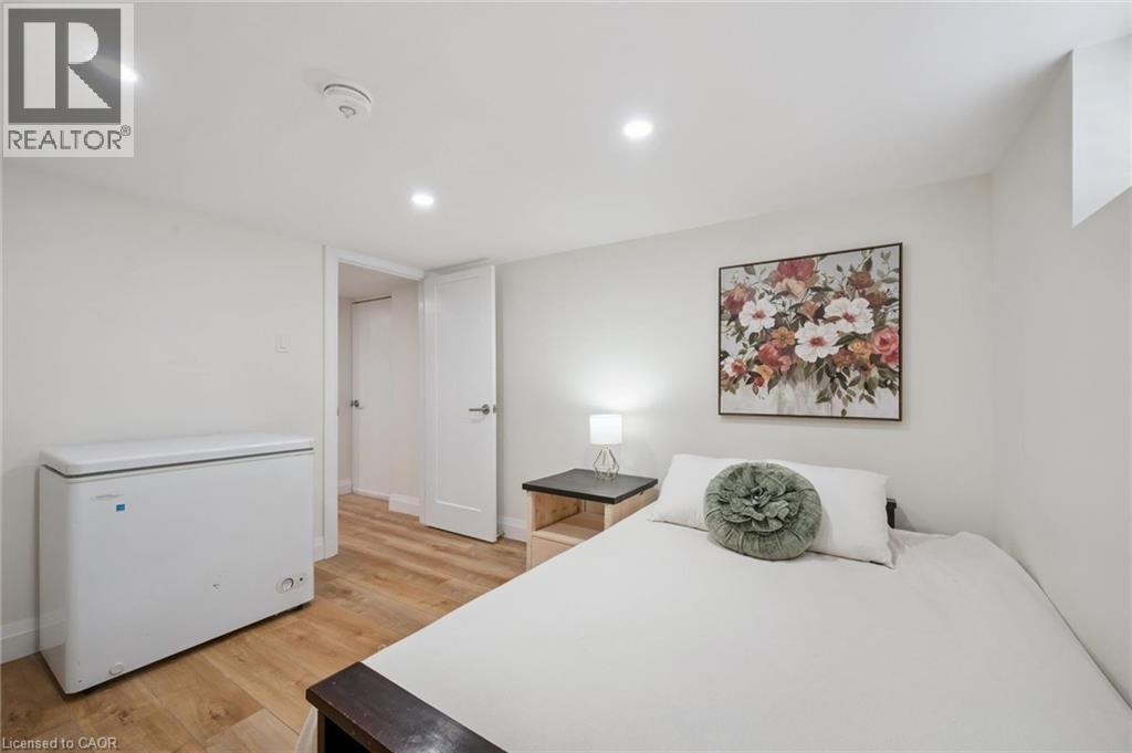 Bedroom with light wood finished floors and recessed lighting - 699 Frederick Street, Kitchener, ON - Indoor Photo Showing Bedroom
