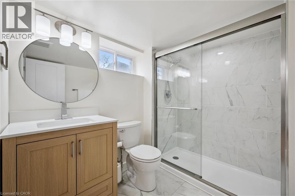 Bathroom featuring vanity, a marble finish shower, and light marble finish flooring - 699 Frederick Street, Kitchener, ON - Indoor Photo Showing Bathroom