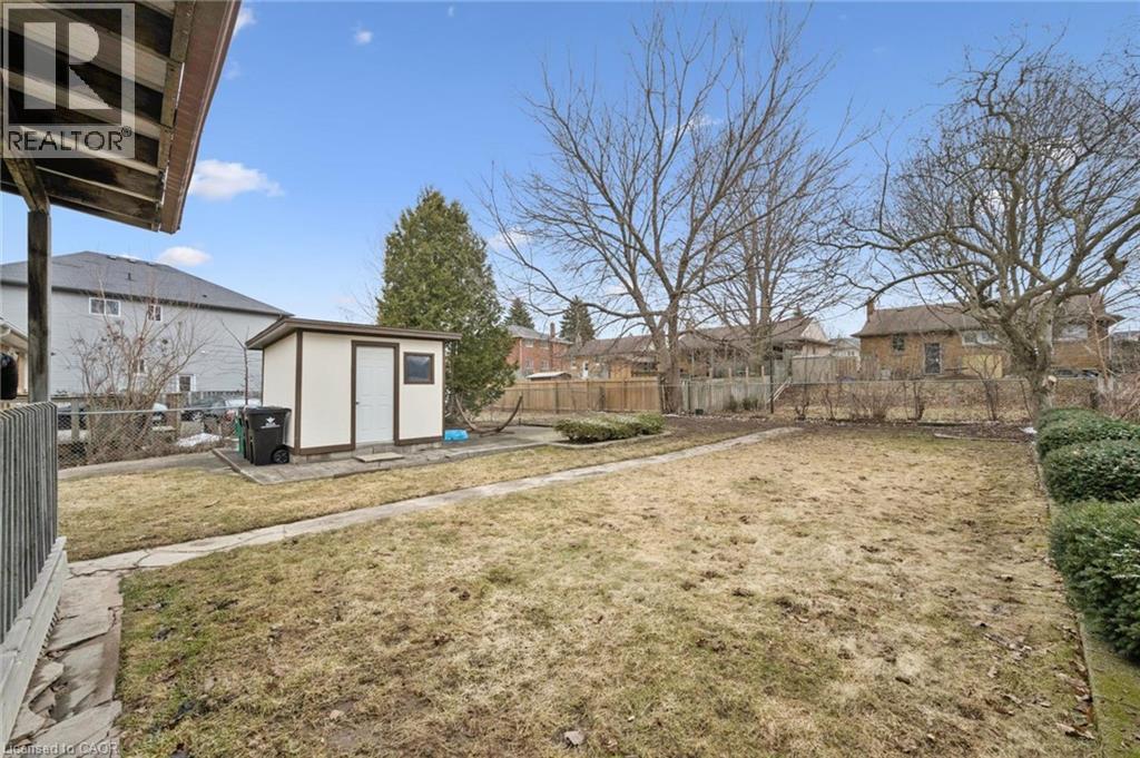 Fenced backyard with a storage shed and a residential view - 699 Frederick Street, Kitchener, ON - Outdoor