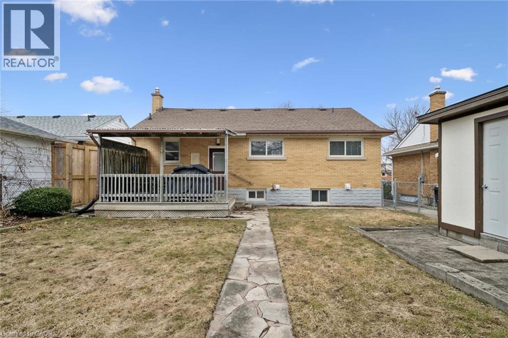Rear view of property featuring a wooden deck, brick siding, a fenced backyard, a chimney, and a patio - 699 Frederick Street, Kitchener, ON - Outdoor With Deck Patio Veranda With Exterior