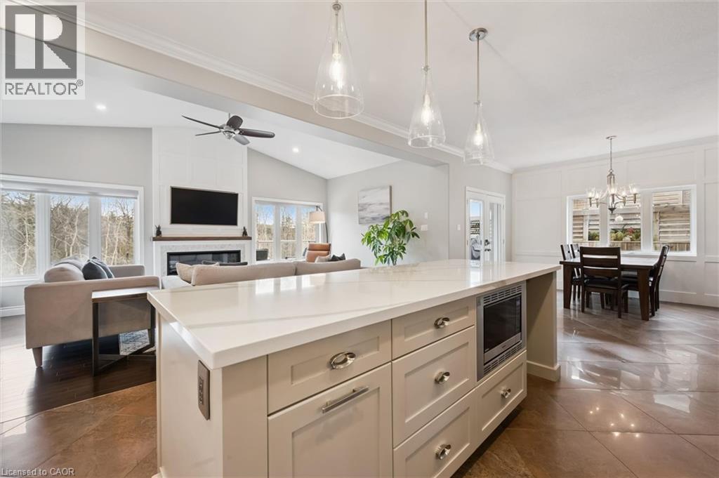 Kitchen featuring vaulted ceiling, a center island, open floor plan, healthy amount of natural light, and stainless steel microwave - 469 Woodbine Avenue, Kitchener, ON - Indoor Photo Showing Other Room