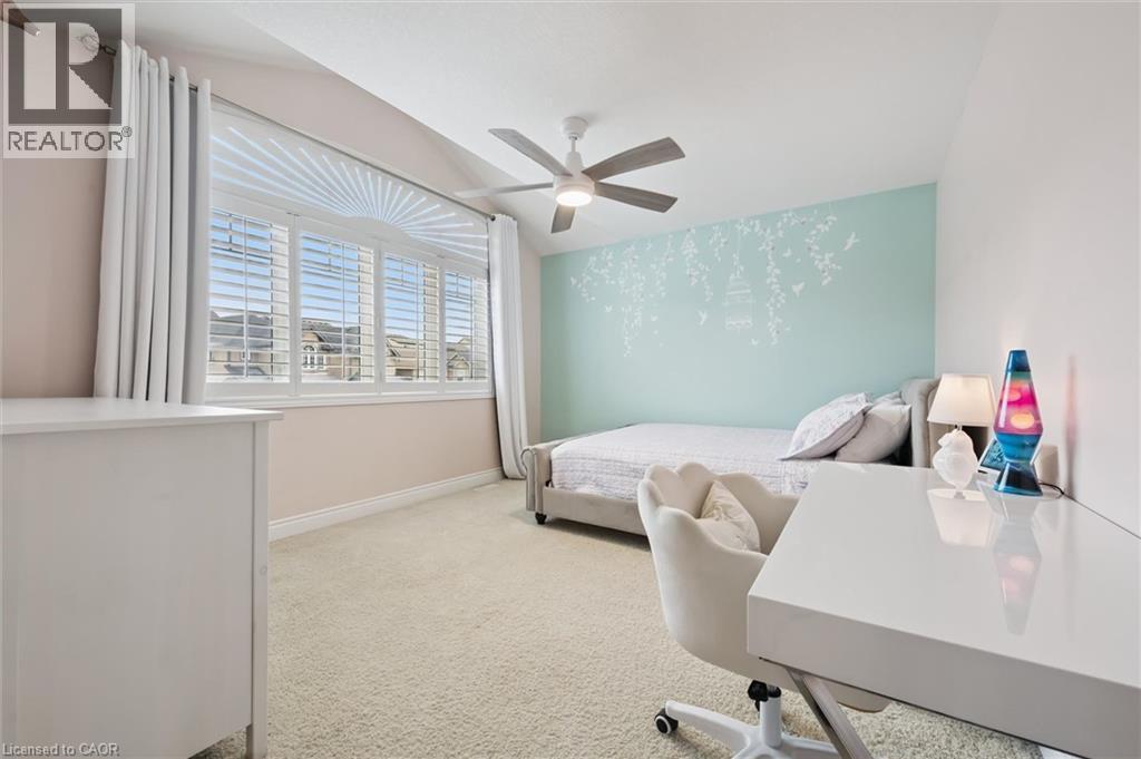 Bedroom featuring light carpet, ceiling fan, vaulted ceiling, and an accent wall - 469 Woodbine Avenue, Kitchener, ON - Indoor Photo Showing Bedroom