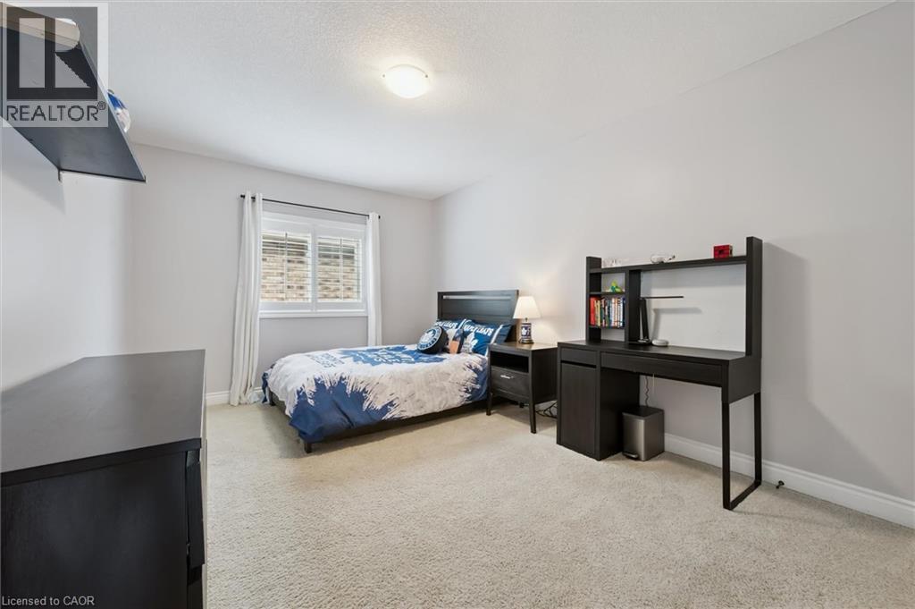 Bedroom featuring baseboards and light colored carpet - 469 Woodbine Avenue, Kitchener, ON - Indoor Photo Showing Bedroom