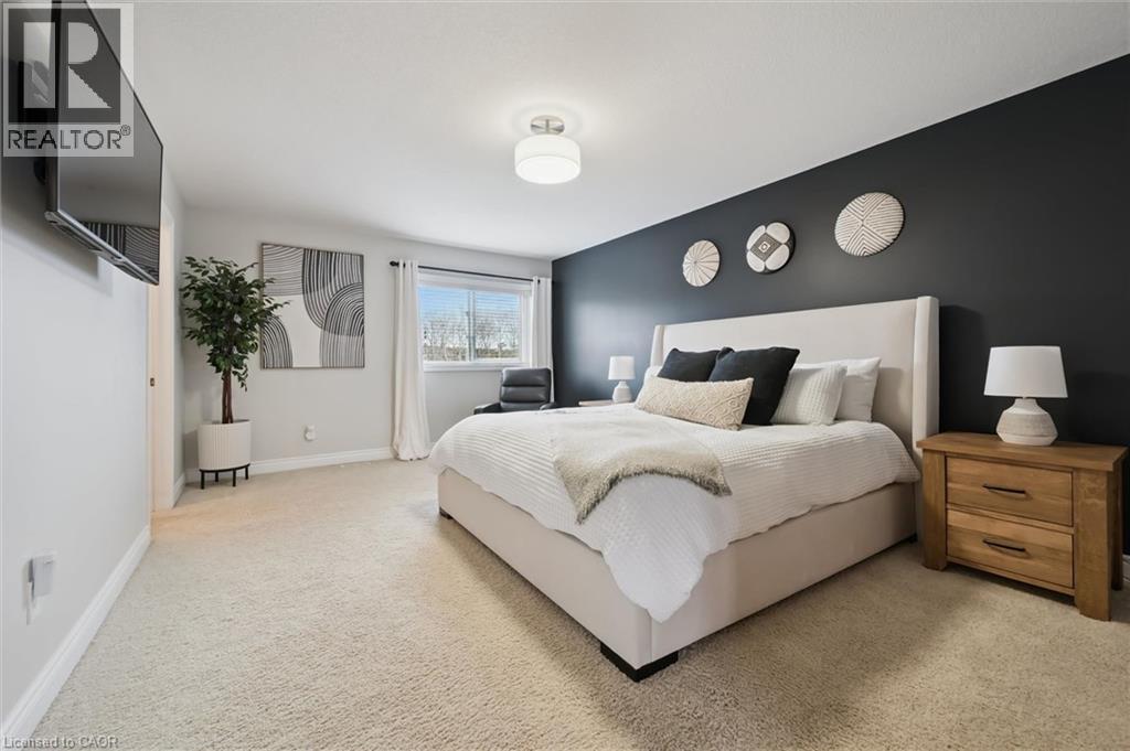 Bedroom featuring light carpet and baseboards - 469 Woodbine Avenue, Kitchener, ON - Indoor Photo Showing Bedroom
