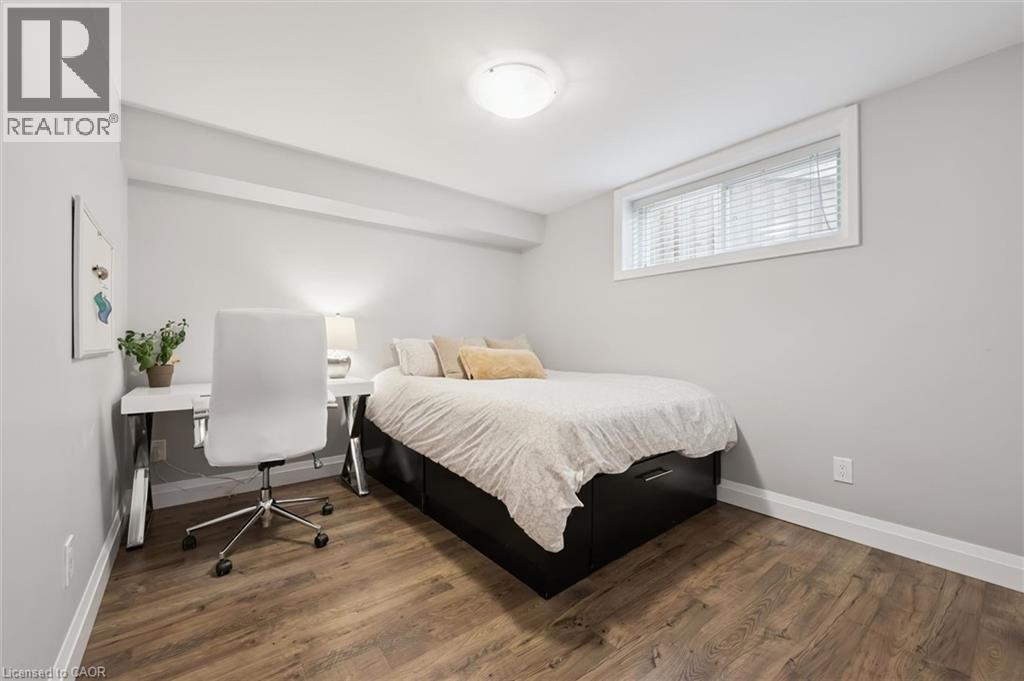 Bedroom with dark wood-type flooring and a desk - 469 Woodbine Avenue, Kitchener, ON - Indoor Photo Showing Bedroom