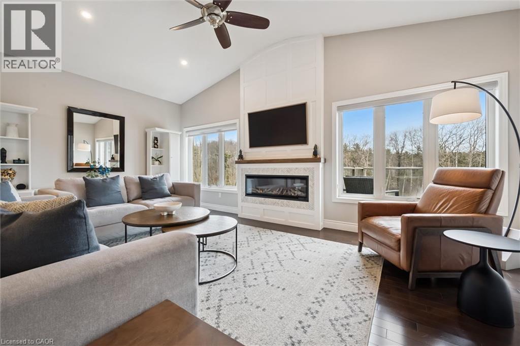 Living room with ceiling fan, dark wood-style floors, a large fireplace, vaulted ceiling, and recessed lighting - 469 Woodbine Avenue, Kitchener, ON - Indoor Photo Showing Living Room With Fireplace