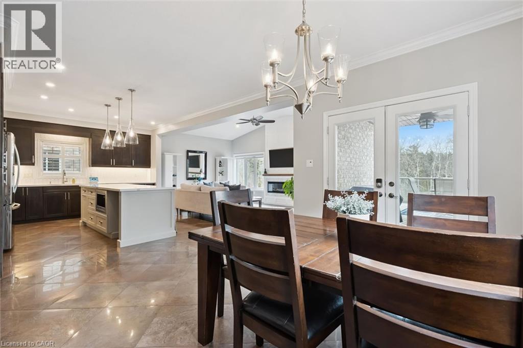 Dining room with a chandelier, a ceiling fan, healthy amount of natural light, crown molding, and french doors - 469 Woodbine Avenue, Kitchener, ON - Indoor