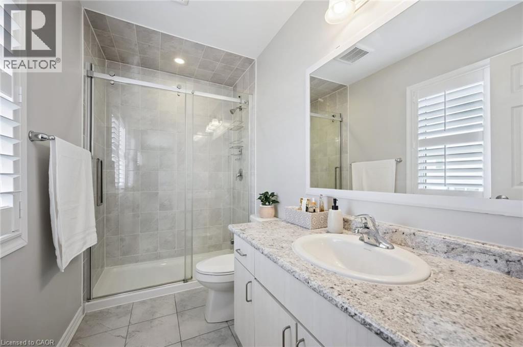 Full bathroom featuring healthy amount of natural light, vanity, a shower stall, and light marble finish flooring - 38 Park Glen Street, Kitchener, ON - Indoor Photo Showing Bathroom