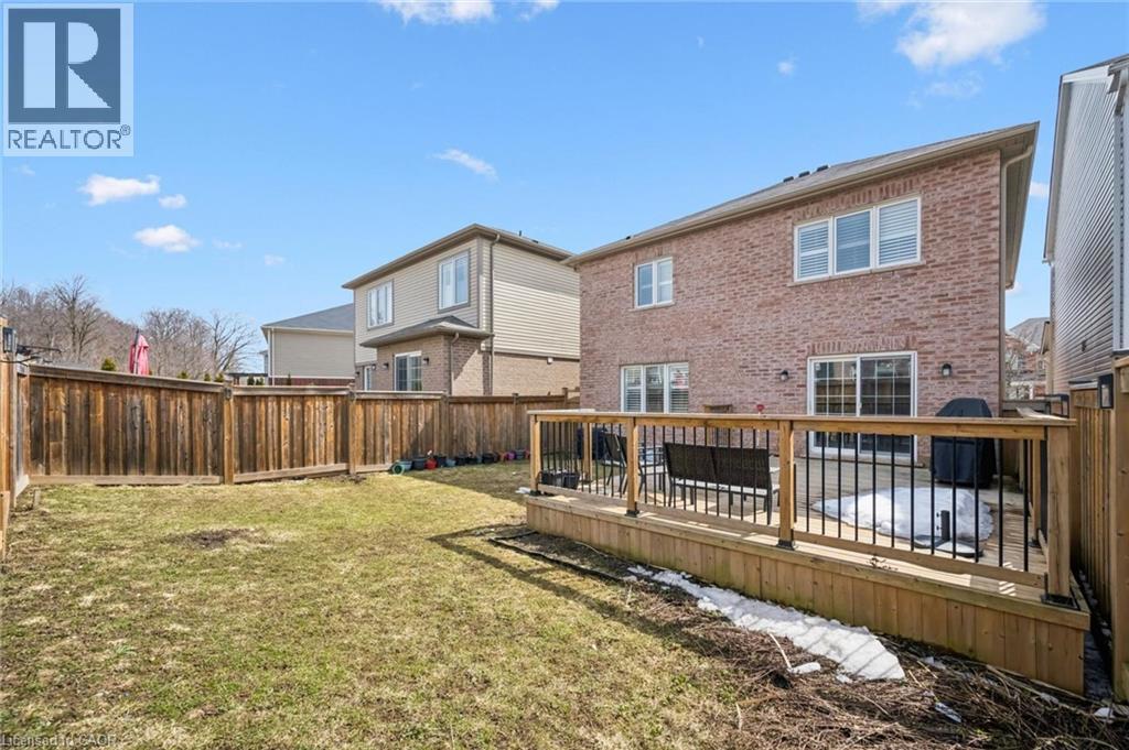 Back of property featuring brick siding, a deck, and a fenced backyard - 38 Park Glen Street, Kitchener, ON - Outdoor With Exterior