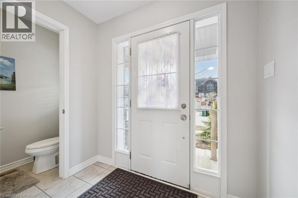Foyer entrance featuring healthy amount of natural light and light tile patterned flooring - 38 Park Glen Street, Kitchener, ON - Indoor Photo Showing Other Room
