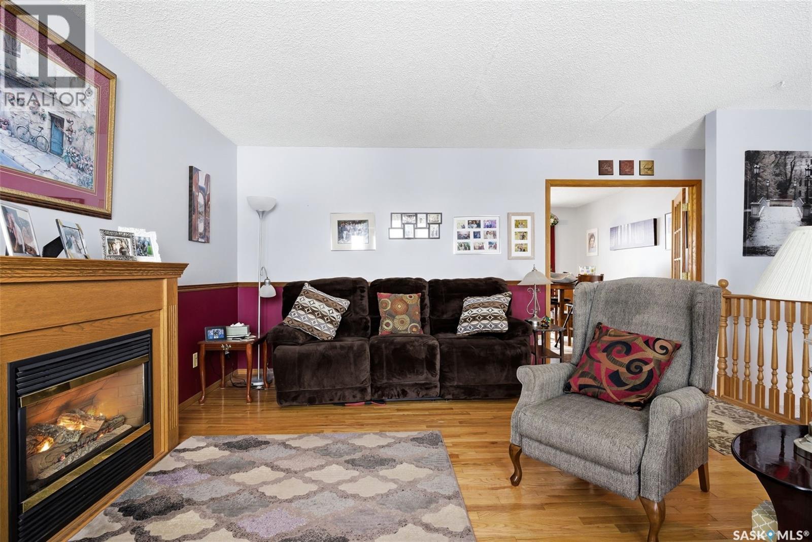7322 Cribbs Bay, Regina, SK - Indoor Photo Showing Living Room With Fireplace