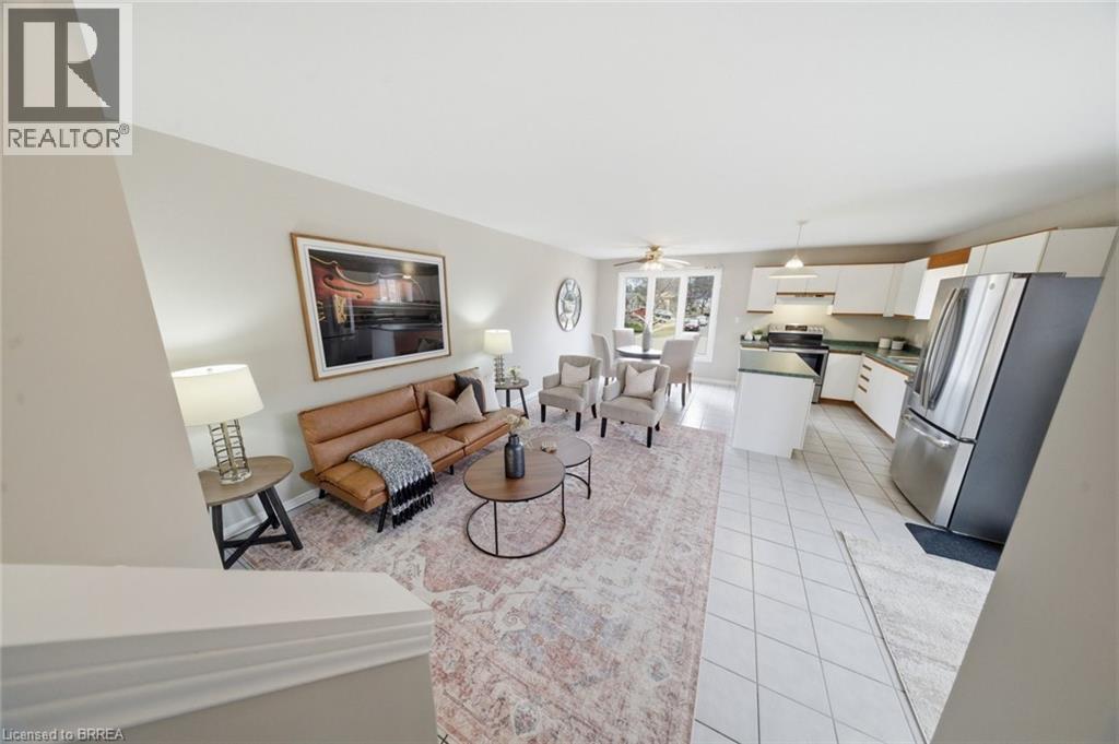 Living room featuring light tile patterned flooring and a ceiling fan - 7 Forest Drive, Paris, ON - Indoor Photo Showing Living Room