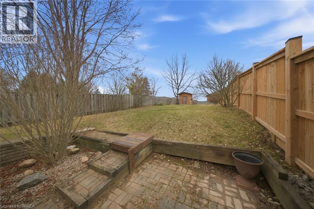 Fenced backyard with a storage unit and a patio area - 7 Forest Drive, Paris, ON - Outdoor