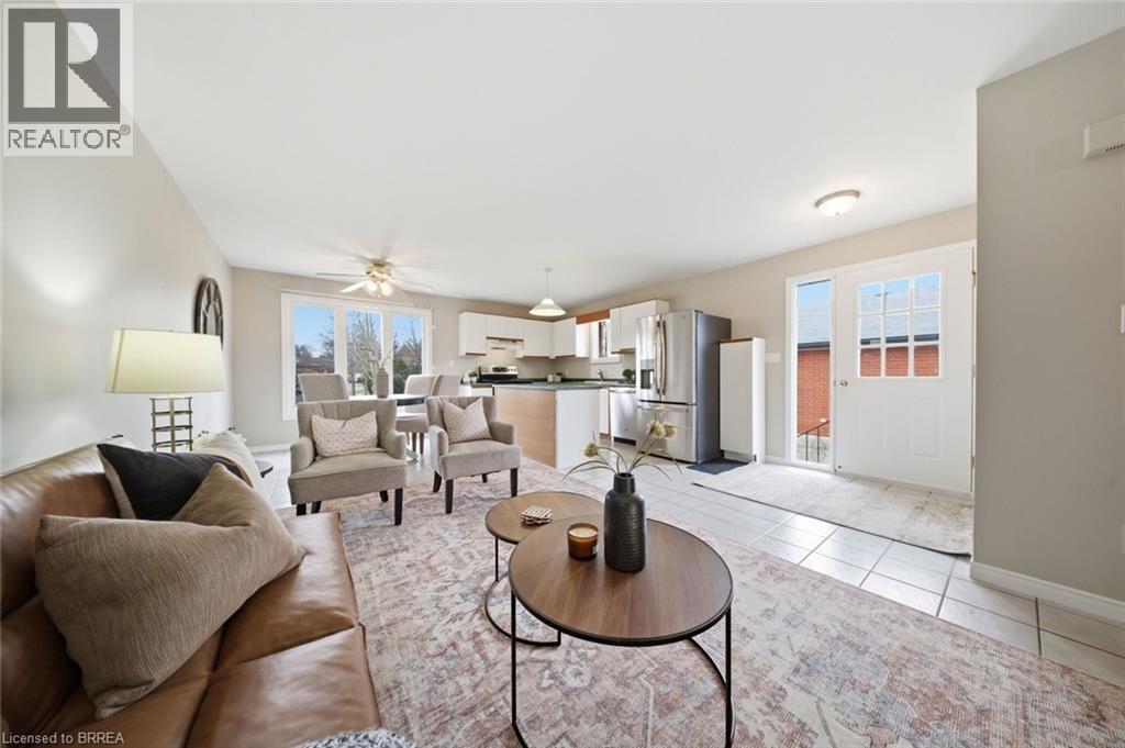 Living area with a ceiling fan and light tile patterned floors - 7 Forest Drive, Paris, ON - Indoor Photo Showing Living Room