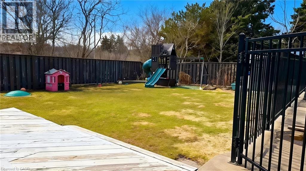 Fenced backyard with a playground - 416 Warrington Drive, Waterloo, ON - Outdoor