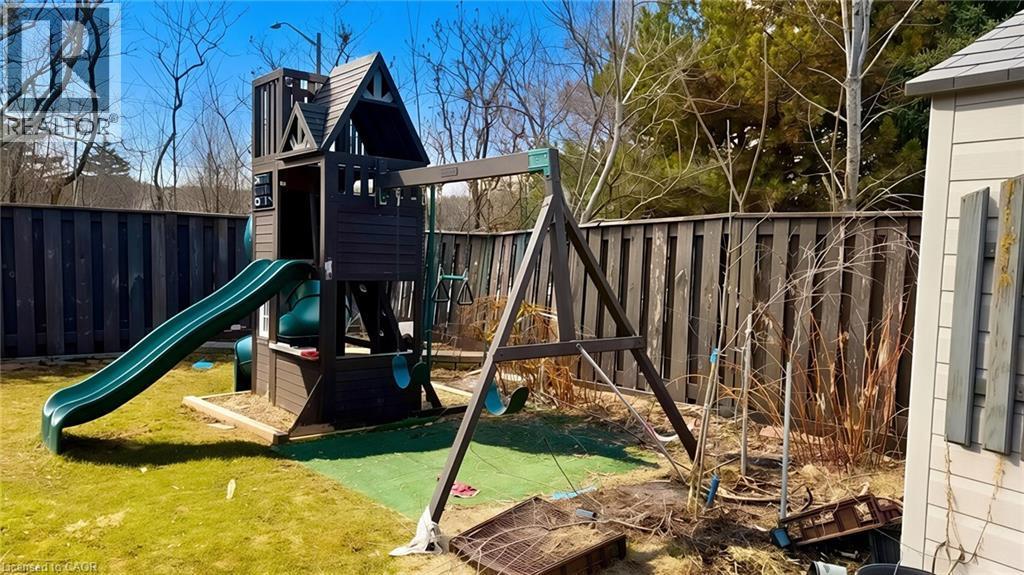 View of play area with a fenced backyard - 416 Warrington Drive, Waterloo, ON - Outdoor