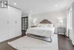 Bright Primary Bedroom His/Hers Closets - 