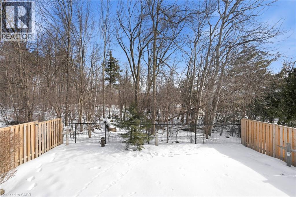 Yard layered in snow featuring view of wooded area - 18 Webster Way, Georgetown, ON - Outdoor