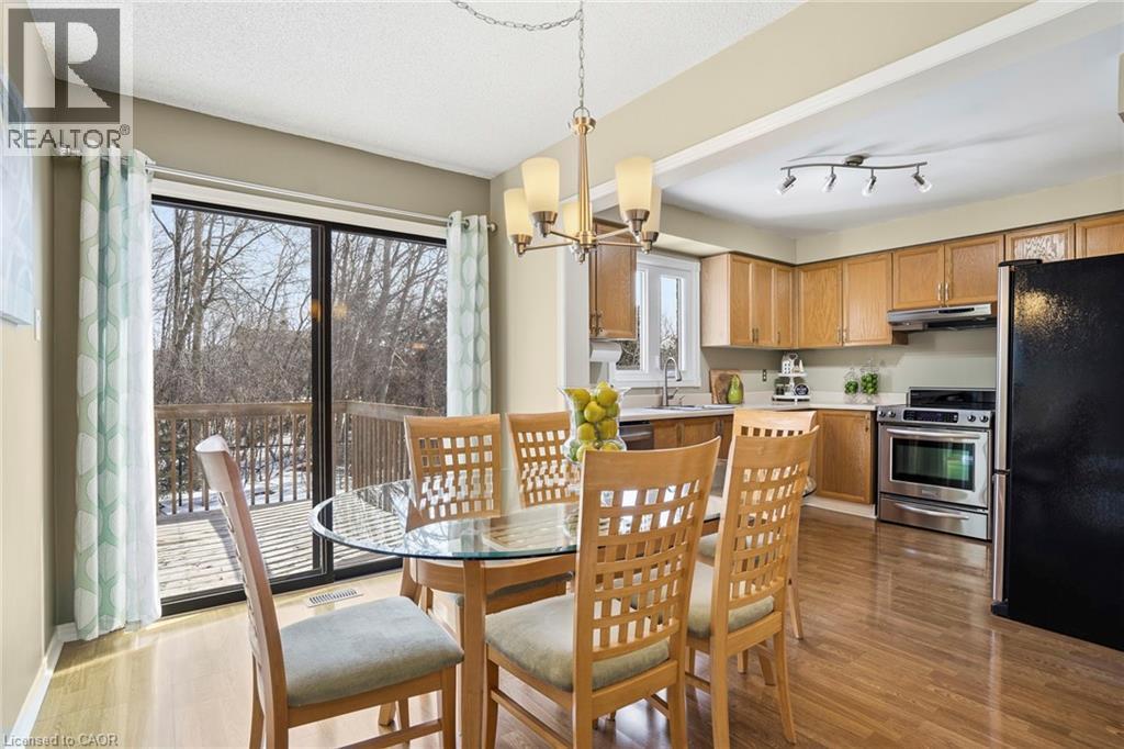 Dining room with hanging lights and dark wood finished floors - 18 Webster Way, Georgetown, ON - Indoor