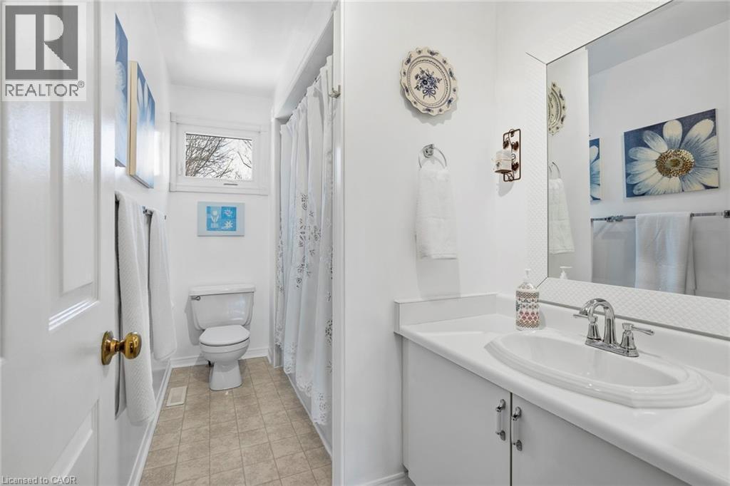 Bathroom with vanity, curtained shower, and light tile patterned flooring - 18 Webster Way, Georgetown, ON - Indoor Photo Showing Bathroom