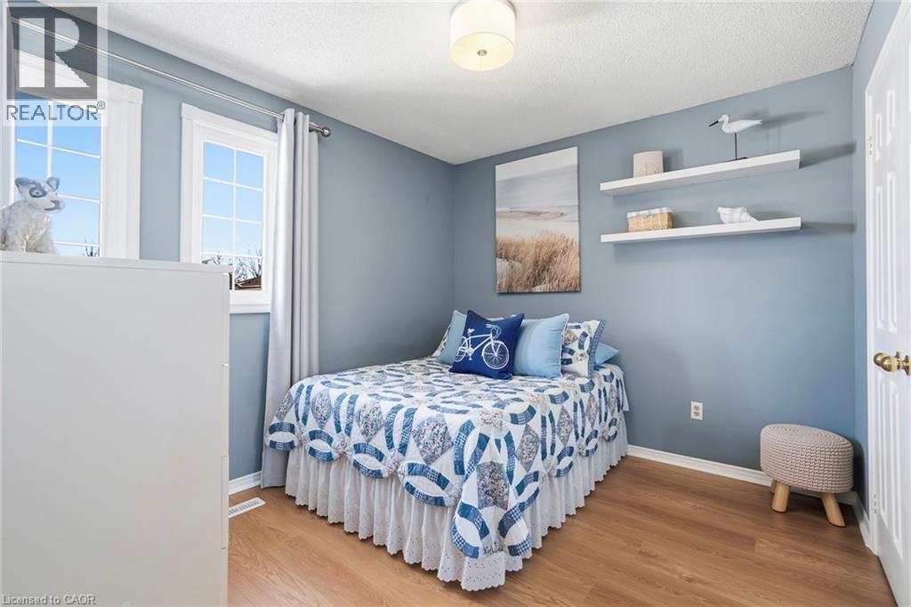 Bedroom featuring wood finished floors and a textured ceiling - 18 Webster Way, Georgetown, ON - Indoor Photo Showing Bedroom