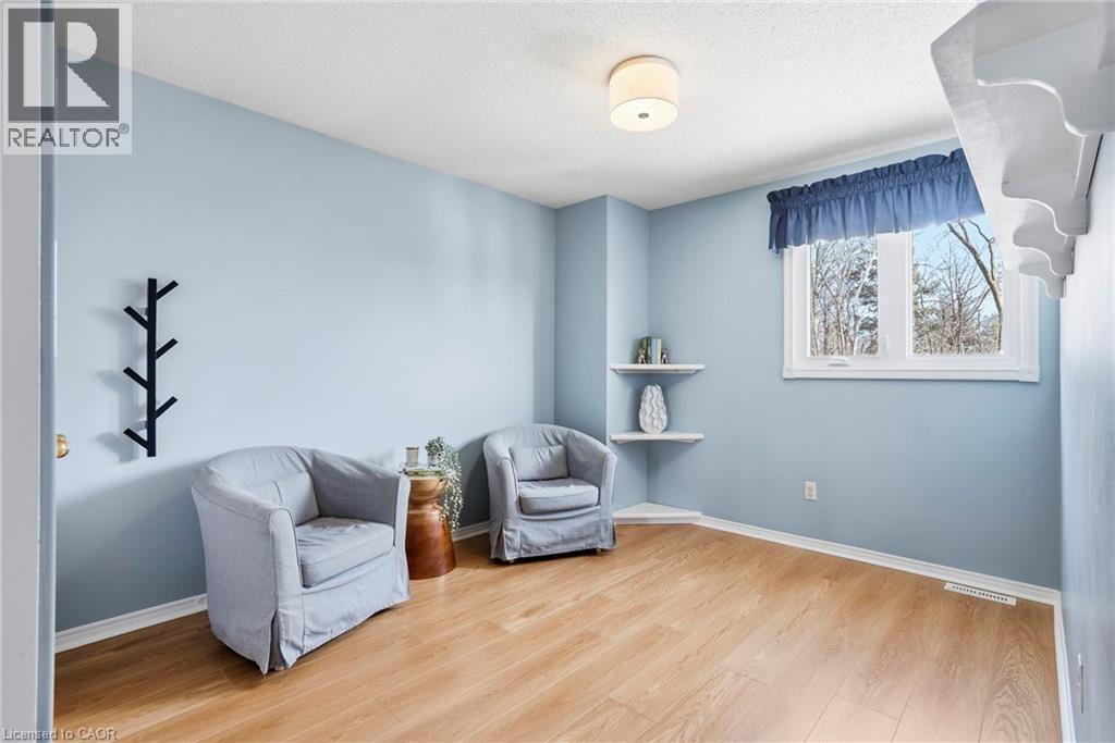 Living area with light wood finished floors and a textured ceiling - 18 Webster Way, Georgetown, ON - Indoor