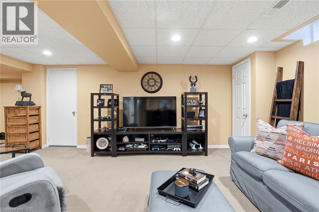 Living room with light colored carpet, a paneled ceiling, and recessed lighting - 18 Webster Way, Georgetown, ON - Indoor Photo Showing Basement