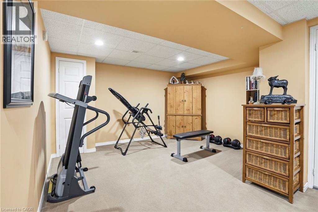 Workout area featuring a paneled ceiling and light carpet - 18 Webster Way, Georgetown, ON - Indoor Photo Showing Gym Room