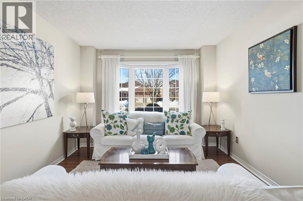 Living area with wood finished floors and a textured ceiling - 18 Webster Way, Georgetown, ON - Indoor Photo Showing Living Room