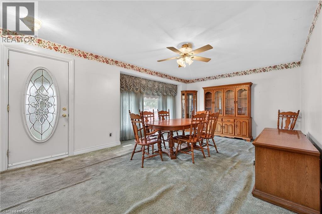 Dining area with ceiling fan and light carpet - 21 Bluebird Avenue, Hamilton, ON - Indoor Photo Showing Dining Room