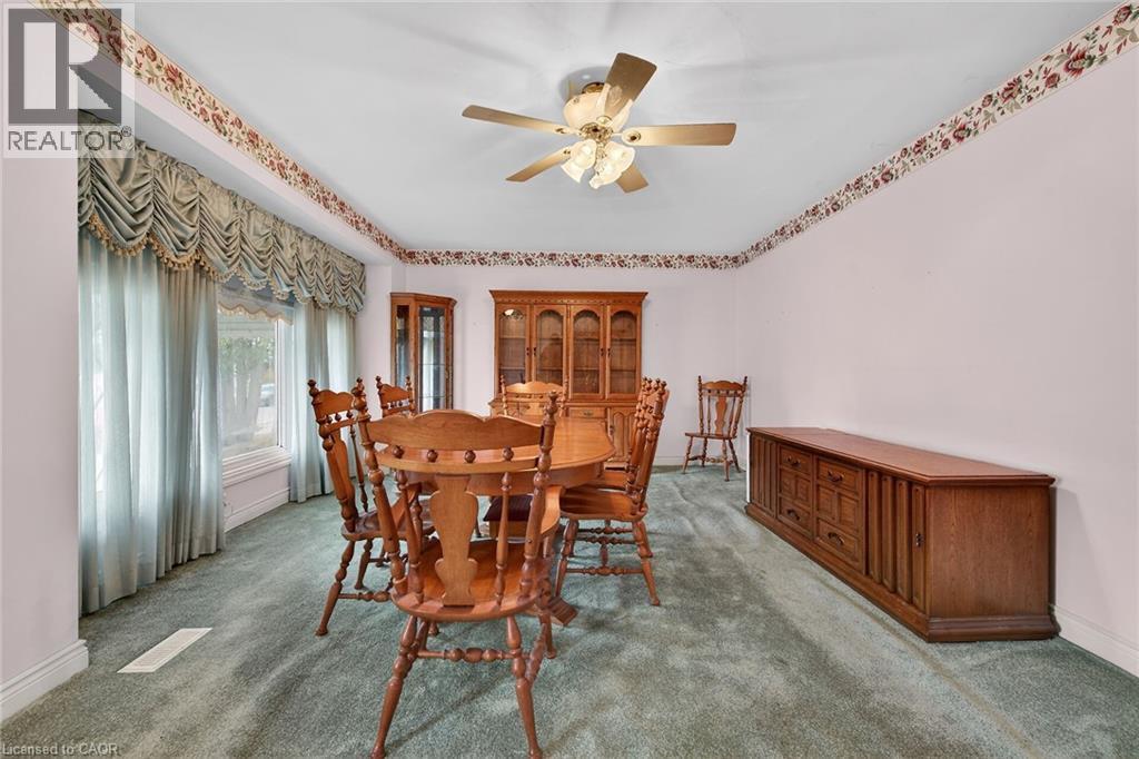 Dining area featuring ceiling fan and carpet - 21 Bluebird Avenue, Hamilton, ON - Indoor Photo Showing Dining Room