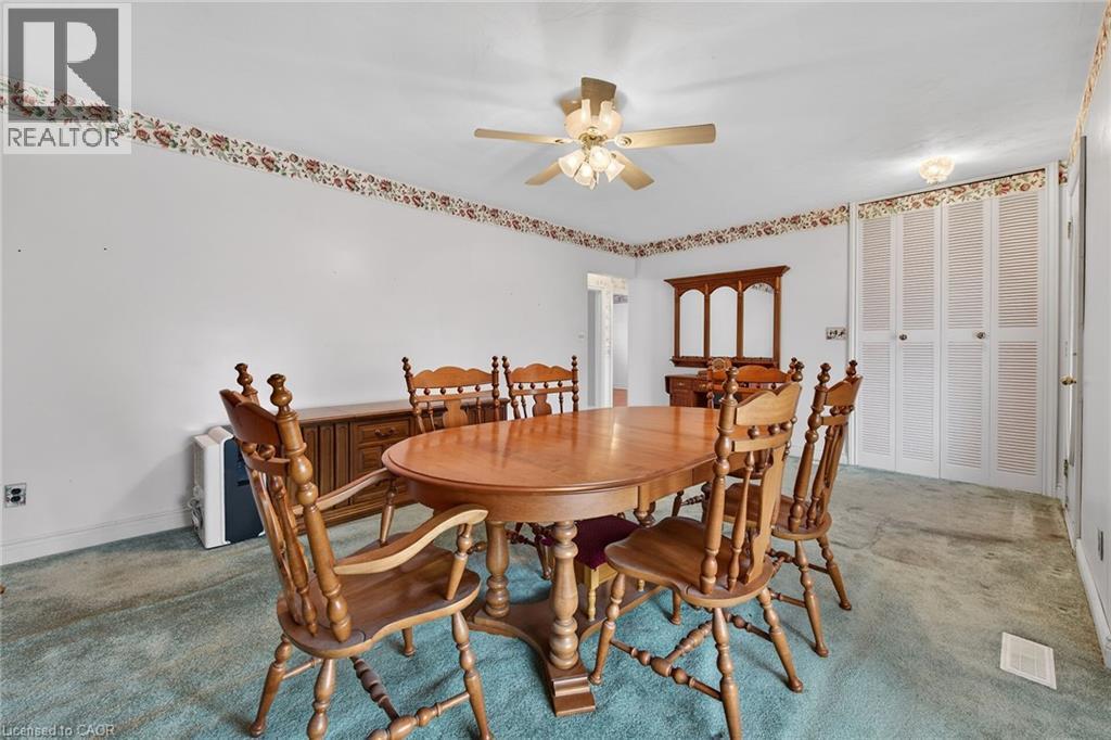 Carpeted dining room featuring ceiling fan - 21 Bluebird Avenue, Hamilton, ON - Indoor Photo Showing Dining Room