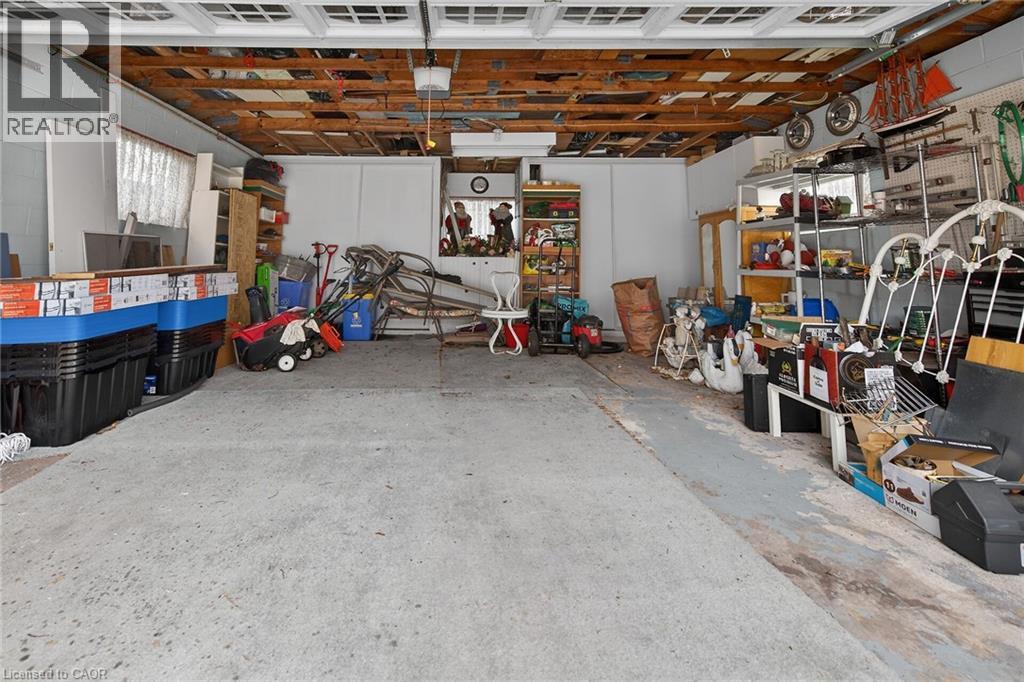 Garage with concrete block wall - 21 Bluebird Avenue, Hamilton, ON - Indoor Photo Showing Basement